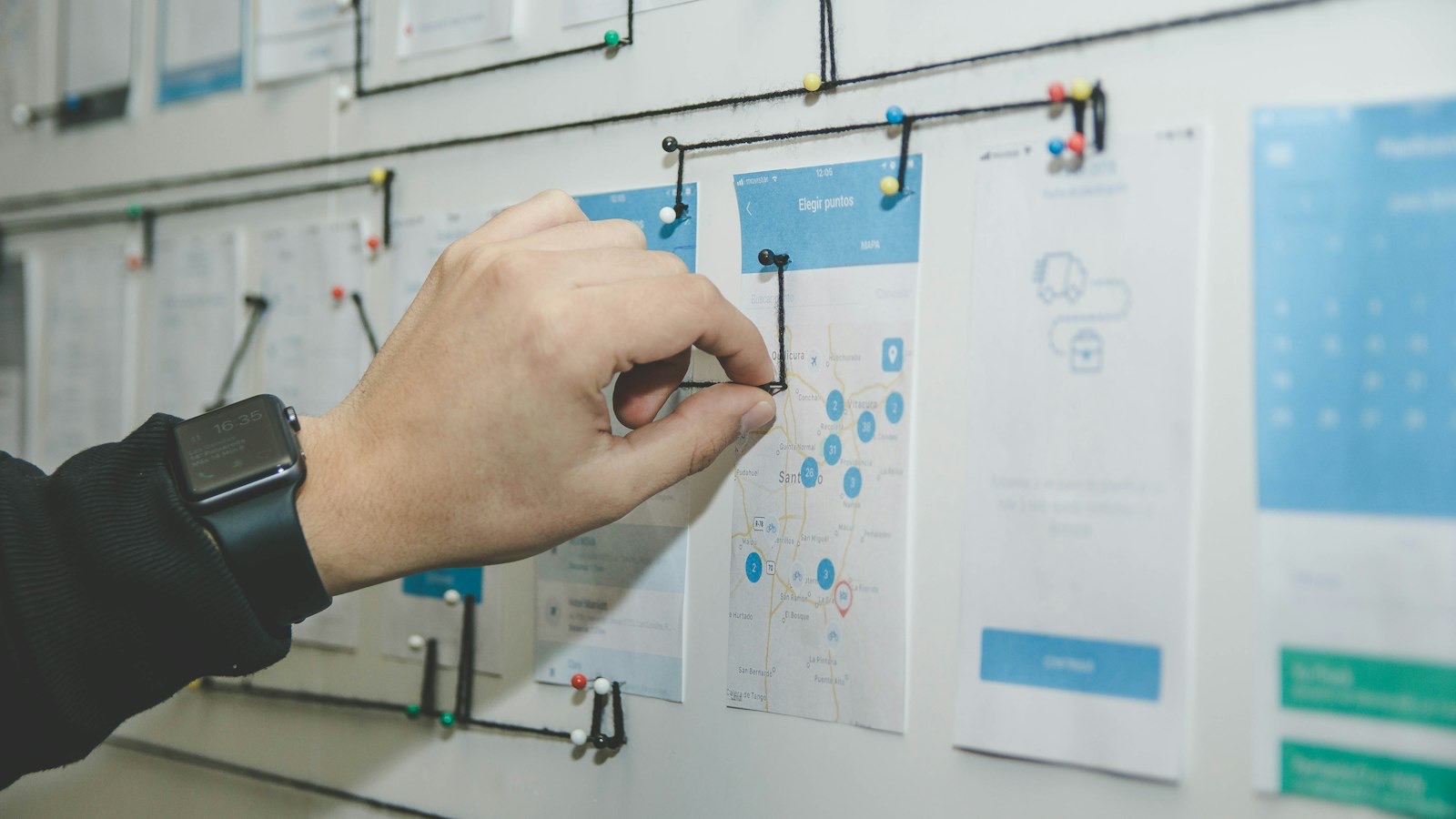 Founder sketching out a mobile app plan on a whiteboard before development starts