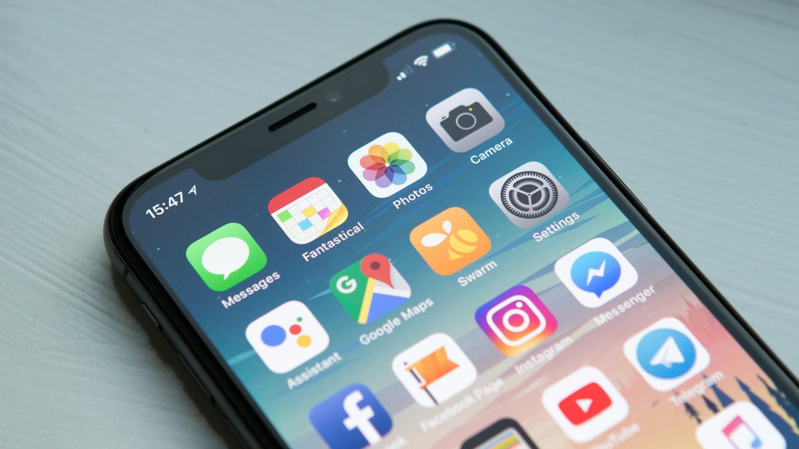Phone and laptop side by side representing mobile and web apps