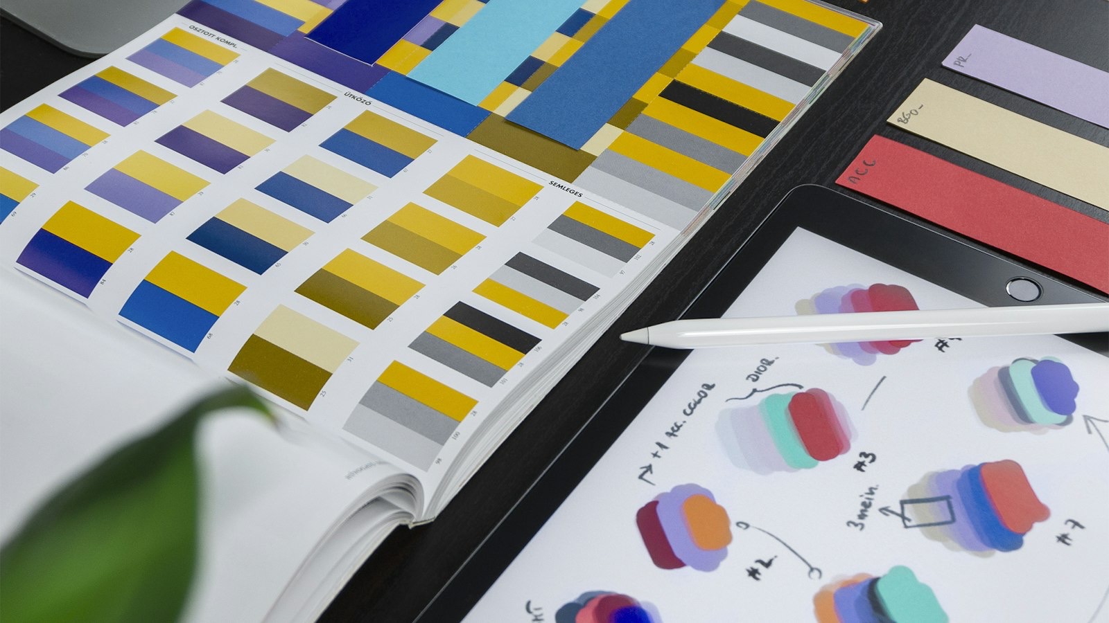 Logo sketches, colour swatches, and typography samples laid out during a brand identity design process